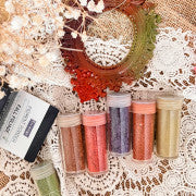 Decor Pigment Powder Set, 6 colors each, Fall Foliage displayed in jars with floral accents on lace background.