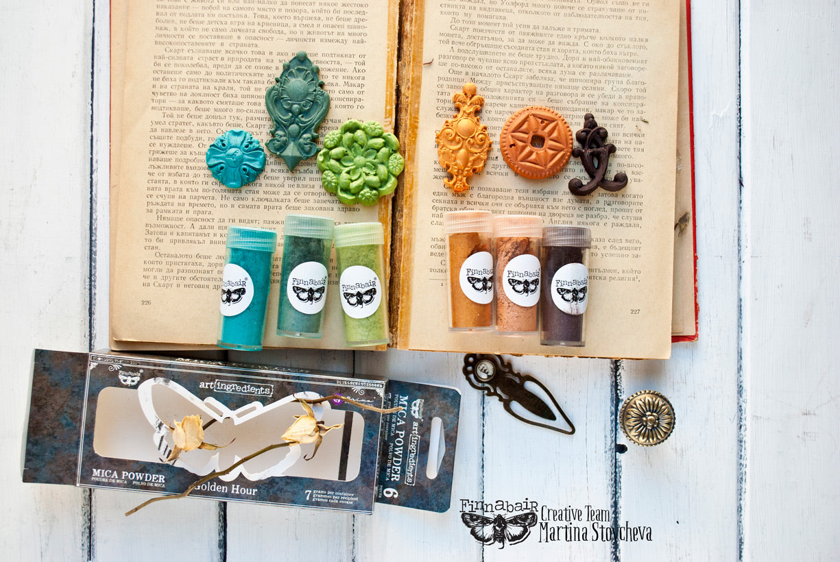 Mica Powder Set, Golden Hour with vibrant powders and decorative accents on an open book background.