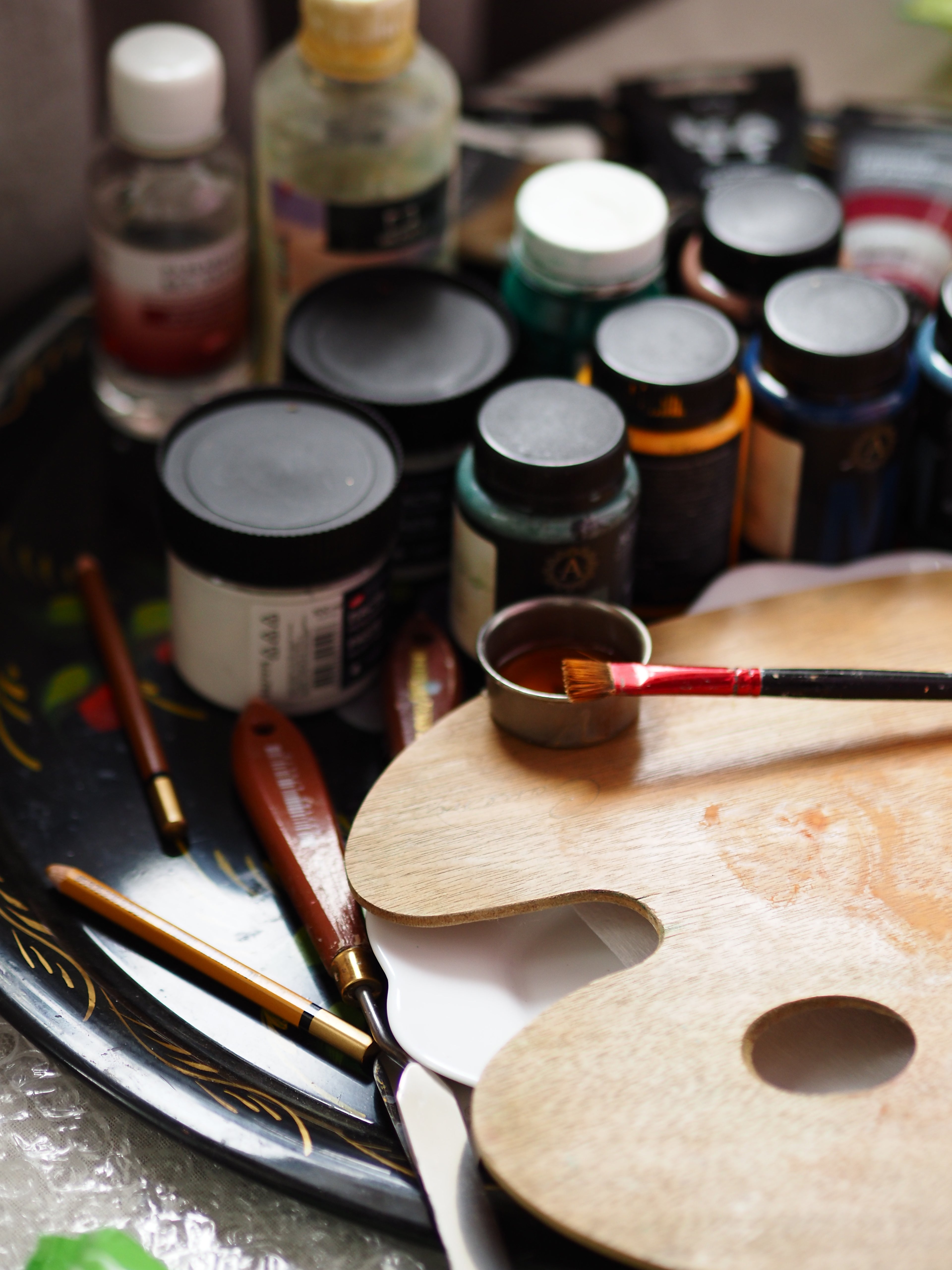 An artist's palette with brushes and premium paints, showcasing DIY décor supplies and creative tools for home décor.