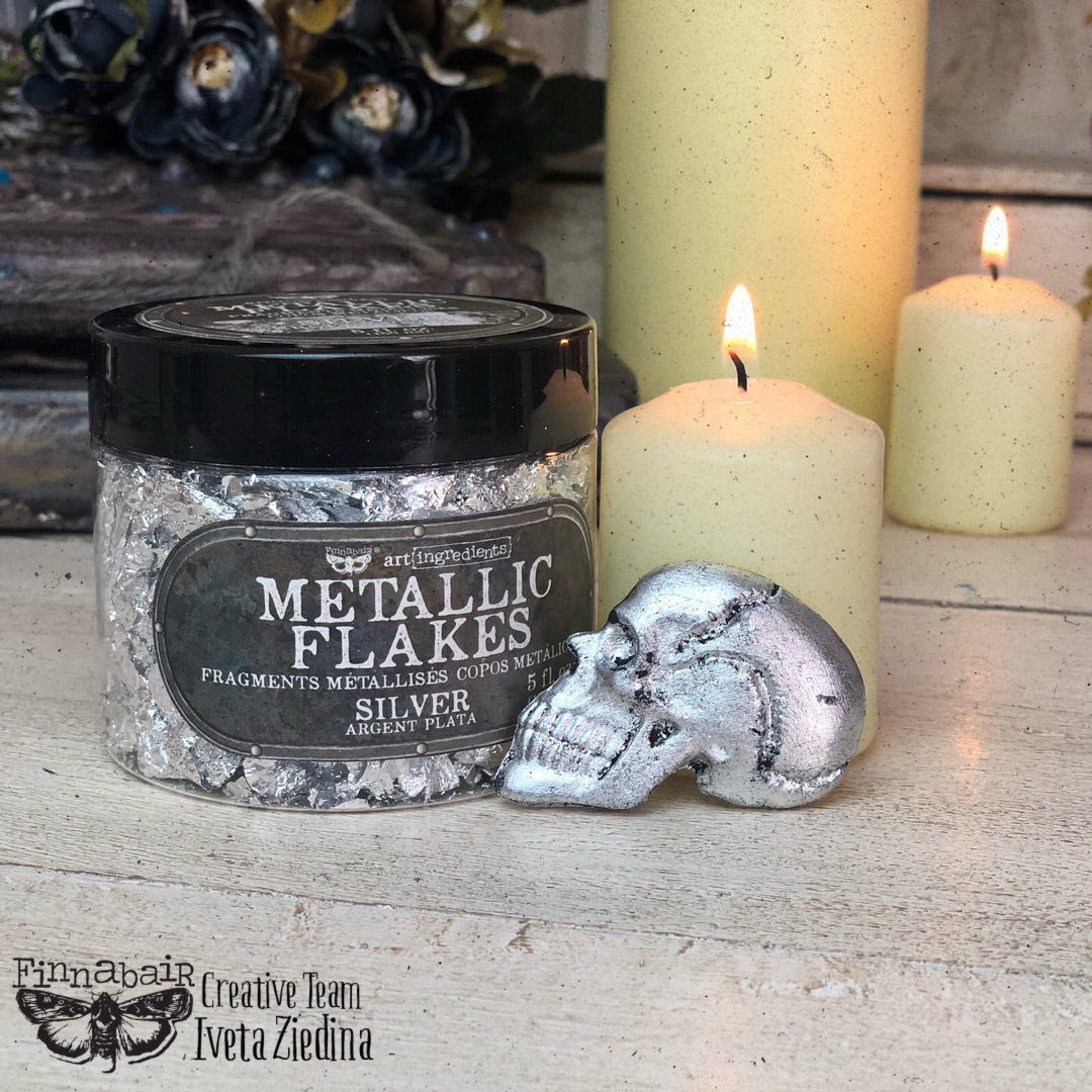 Fine Mica Flakes, Silver in jar with skull accent, perfect for DIY décor and artistic finishes.