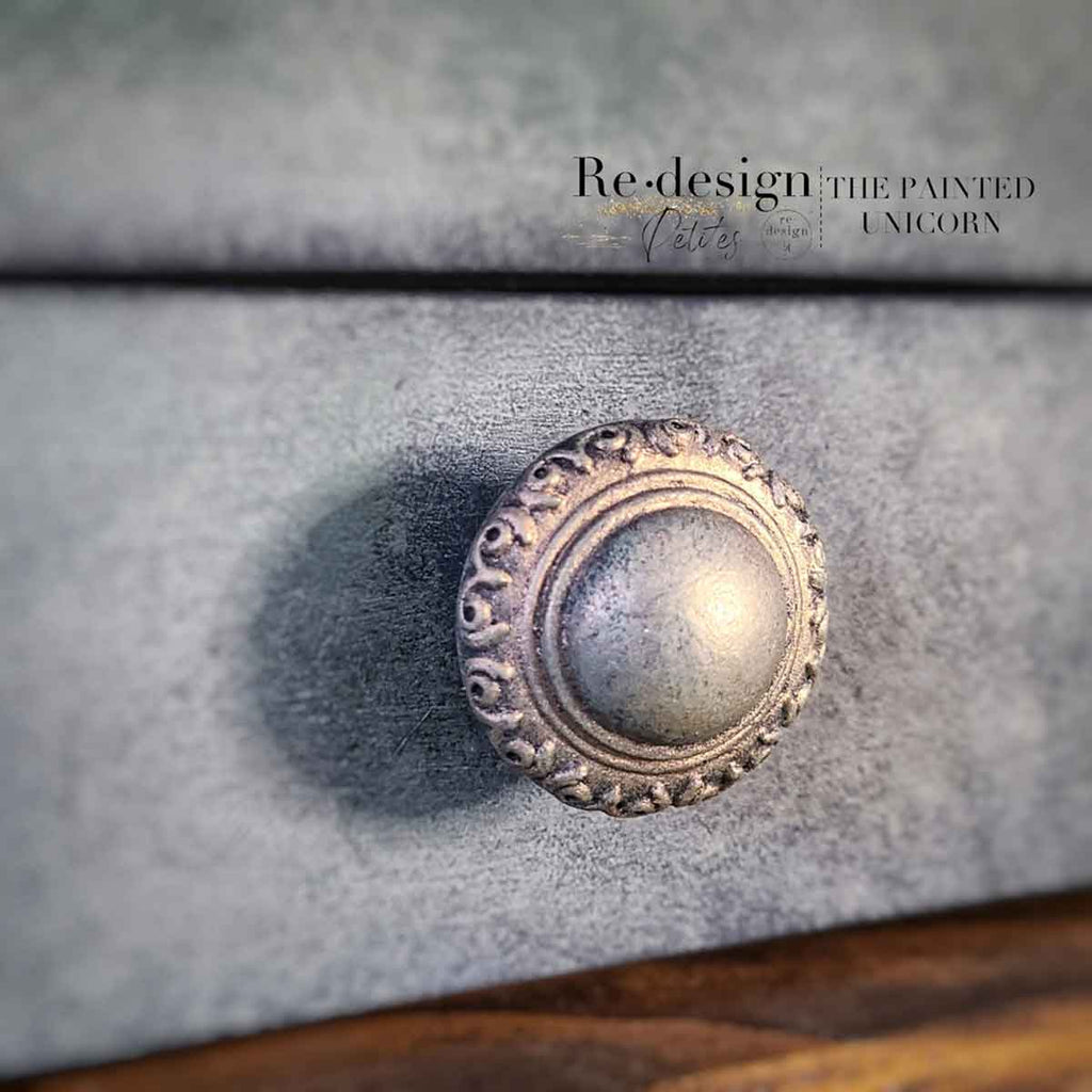 CeCe Knob Mould - Luxe Ornate, 1 knob, set includes hardware on a painted cabinet surface.