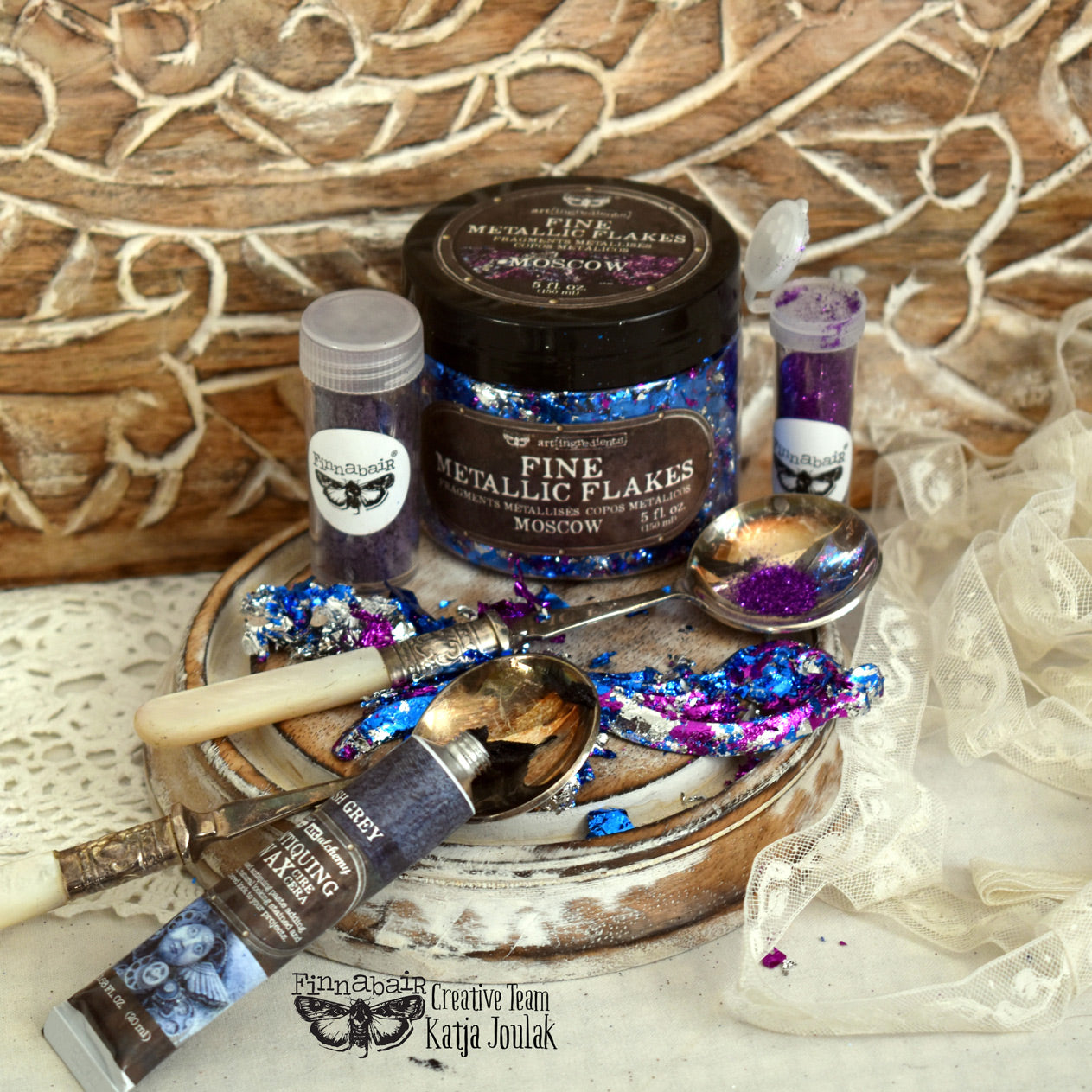 Fine Mica Flakes, Paris with art tools on a wooden surface, ideal for DIY décor and creative projects.