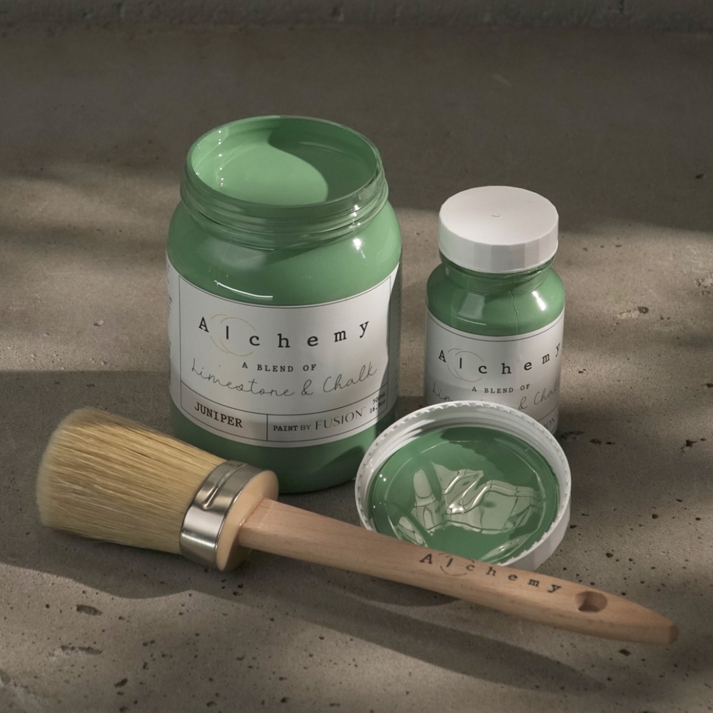 Premium chalk-based paint in Juniper green, accompanied by painting tools for DIY home décor projects.