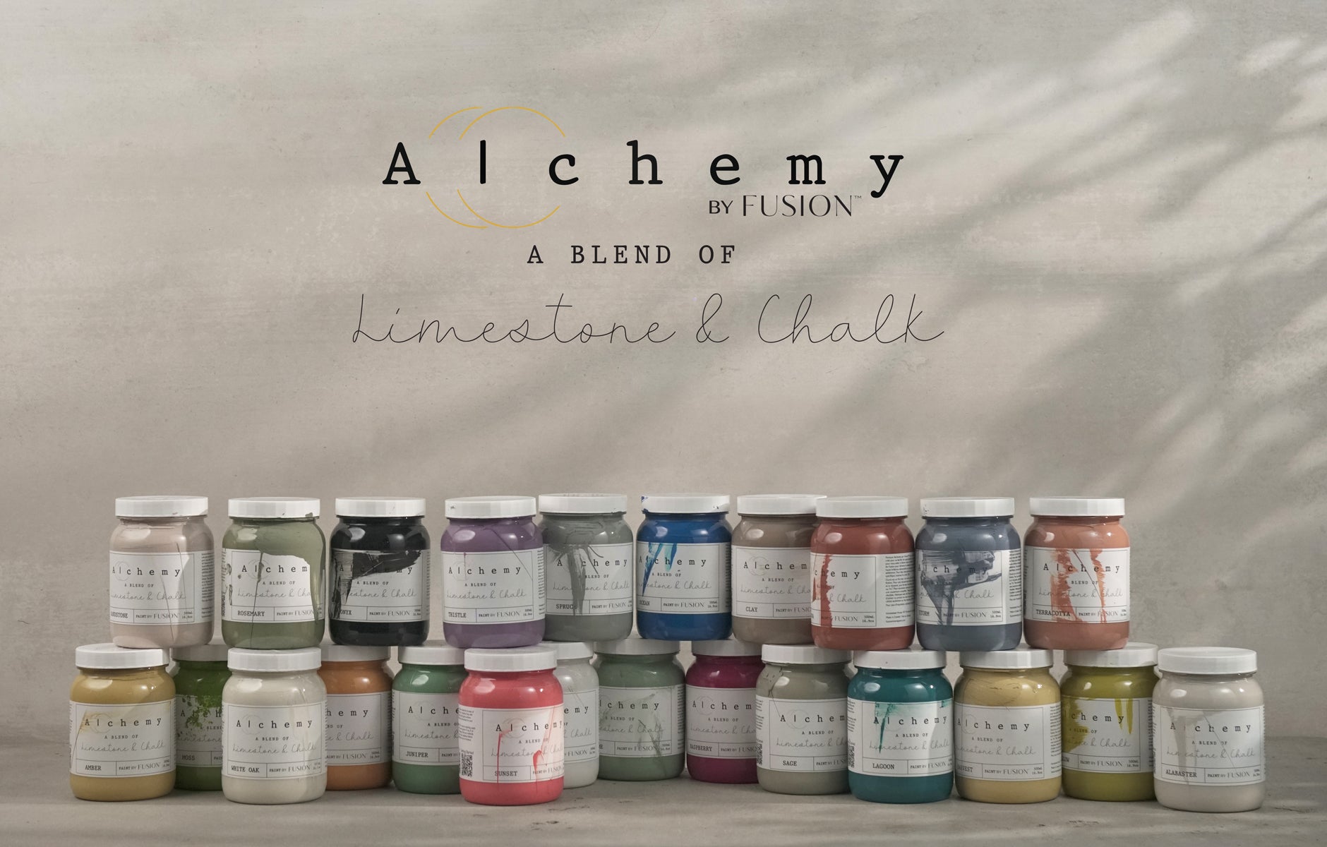A display of premium paints in various colors by Alchemy, perfect for DIY décor and home design projects.